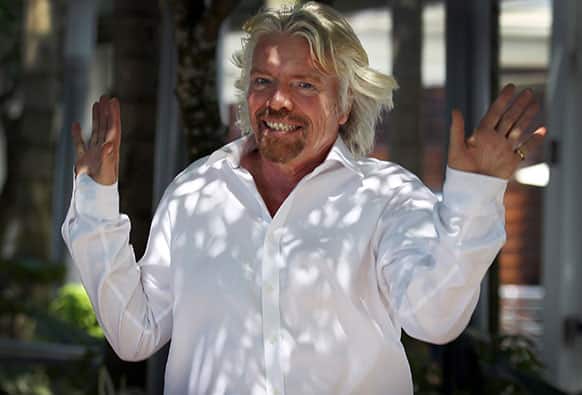 Richard Branson, founder and chairman of the Virgin Group, gestures upon arrival for a press conference in Singapore on the sidelines of the Carbon War Room conference held in the city-state.
