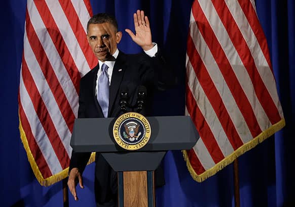 President Barack Obama waves as he steps off stage after speaking at a Democratic fundraiser at the Waldorf Astoria Hotel in New York.