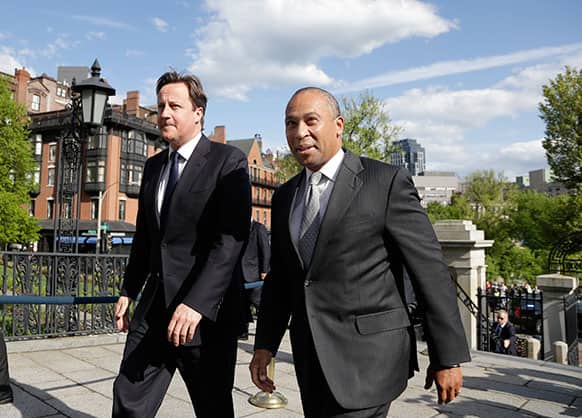 British Prime Minister David Cameron, left, walks with Massachusetts Gov. Deval Patrick into the Massachusetts Statehouse in Boston. Cameron met with Patrick to offer his condolences and discuss lessons that can be learned from the Boston Marathon attacks.