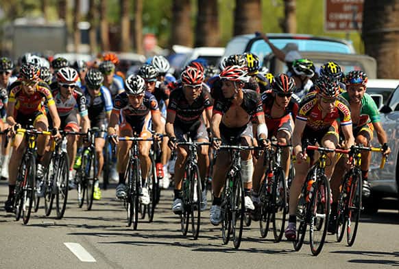 The peloton rapidly approaches leaders on North Palm Canyon Drive in Palm Springs, Calif., during the Amgen Tour of California Bike Race.