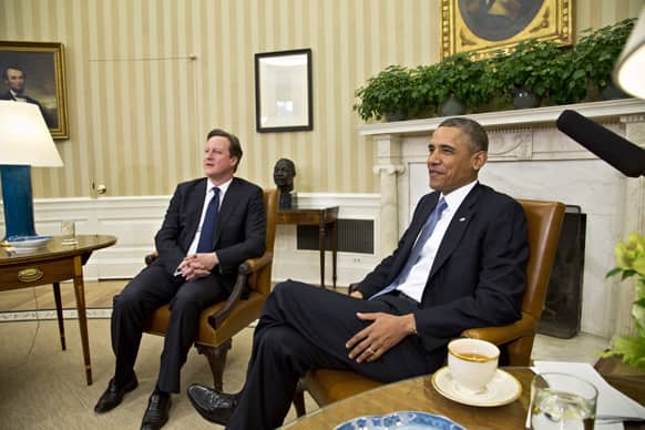 President Barack Obama welcomes British Prime Minister David Cameron in the Oval Office of the White House in Washington.