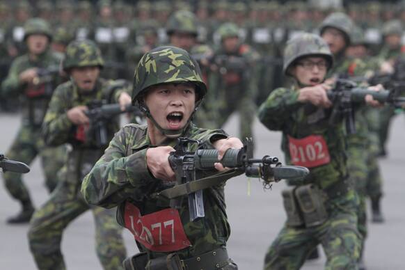 New recruits practice charging with bayonets at a military training center in Hsinchu County, northern Taiwan.