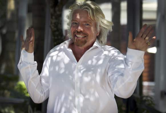 Richard Branson, founder and chairman of the Virgin Group, gestures upon arrival for a press conference, in Singapore on the sidelines of the Carbon War Room conference held in the city-state.