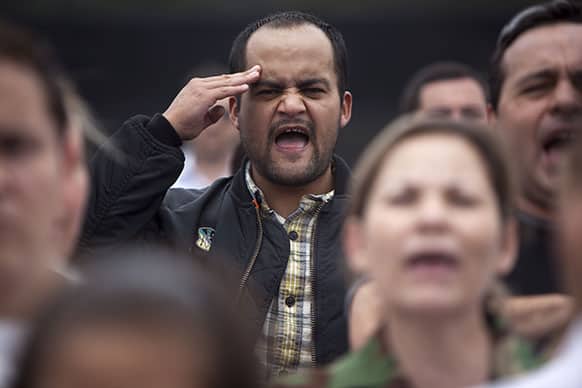 Supporters of former dictator Jose Efrain Rios Montt sing a Guatemalan national anthem during a protest outside the Matamoros prison in Guatemala City.
