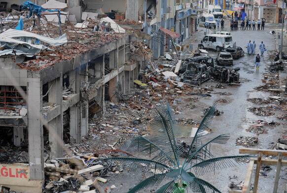 Police forensic officers work at the scene at one of the Saturday explosion sites that killed 46 and injured about 50 others, in Reyhanli, near Turkey`s border with Syria.