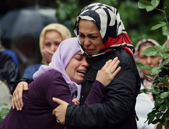 Mourning relatives cry during the burial for one of the 46 victims killed in Saturday explosions in Reyhanli, near Turkey`s border with Syria.