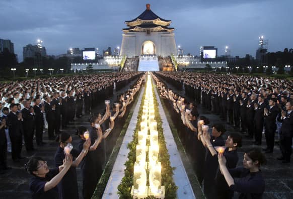 Taiwanese people pray together during the Taiwan National Buddha`s Birthday celebration in front of the Chiang Kai-shek Memorial Hall in Taipei, Taiwan.