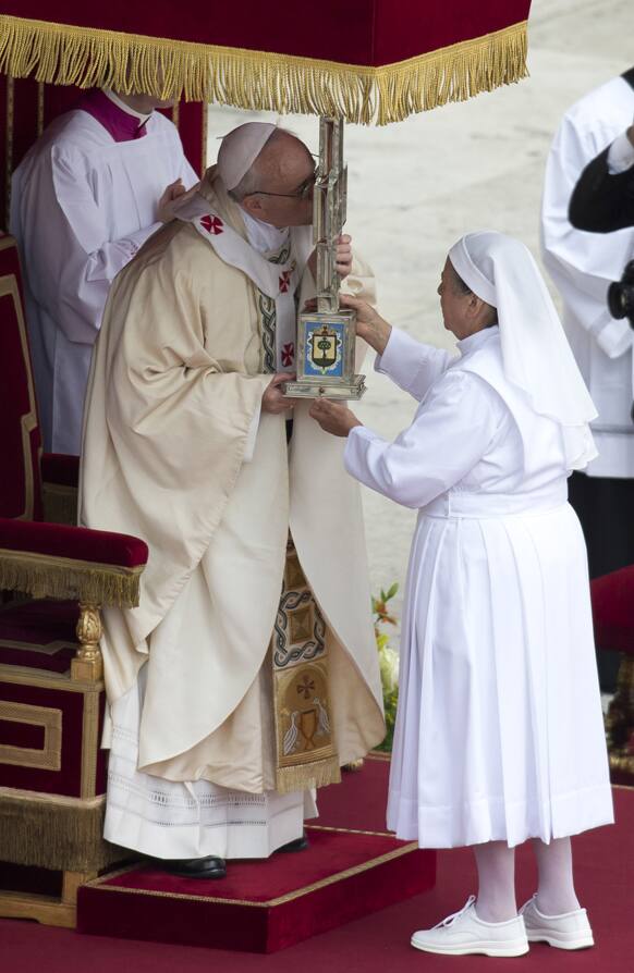 Pope Francis kisses a cross containing relics of Maria Guadalupe Garcia Zavala during the canonization ceremony in St. Peter`s Square at the Vatican.