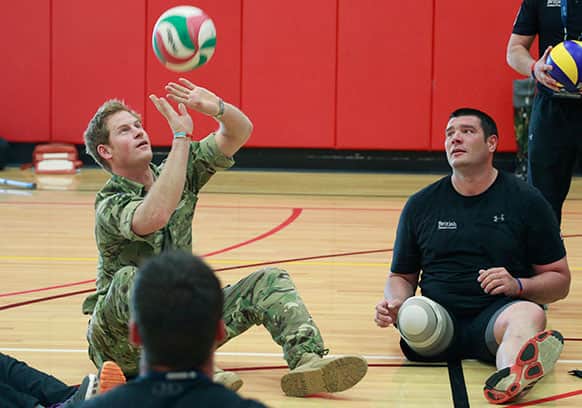 Prince Harry plays volleyball with members of the British Warrior Games Team in a gymnasium before the opening of the 2013 Warrior Games, at the U.S. Olympic Training Center, in Colorado Springs, Colo.