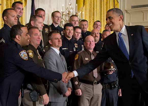 President Barack Obama, right, shakes hands with New York Police Detective Ivan M. Marcano during a ceremony to honor the 2013 National Association of Police Organizations (NAPO) TOP COPS award winners during a ceremony in East Room of the White House.