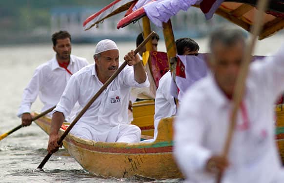 Kashmiri Shikara, or traditional gondola, owners participate in a race on the Dal Lake in Srinagar.