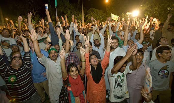 Supporters of Pakistan Muslim League-N party celebrate the primary unofficial results for the country`s parliamentary elections at the party`s headquarter in Lahore, Pakistan.