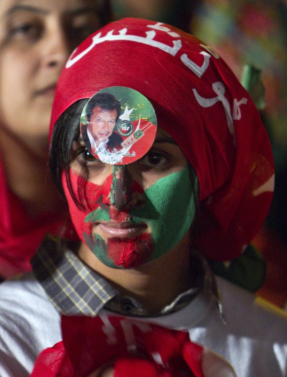 A supporter of Pakistan Tehreek-e-Insaf or Moment for Justice party attends an election campaign rally in Islamabad.