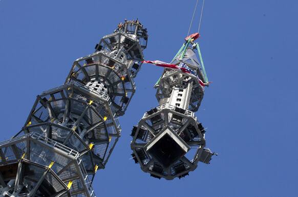 The final piece of spire is hoisted in place on top of One World Trade Center in New York. The addition of the spire, and its raising of the building’s height to 1,776 feet, would make One World Trade Center the tallest structure in the US and third-tallest in the world.