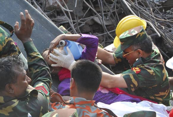 Rescuers carry a survivor pulled out from the rubble of a building that collapsed in Saver, near Dhaka, Bangladesh. Rescue workers in Bangladesh freed the woman buried for 17 days inside the wreckage of a garment factory building that collapsed, killing more than 1,000 people.
