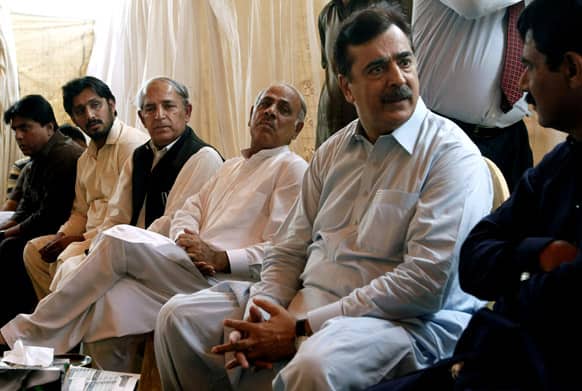 Pakistan`s former Prime Minister Yousuf Raza Gilani sits with people visiting his residence to console over his son`s abduction in Multan, Pakistan.