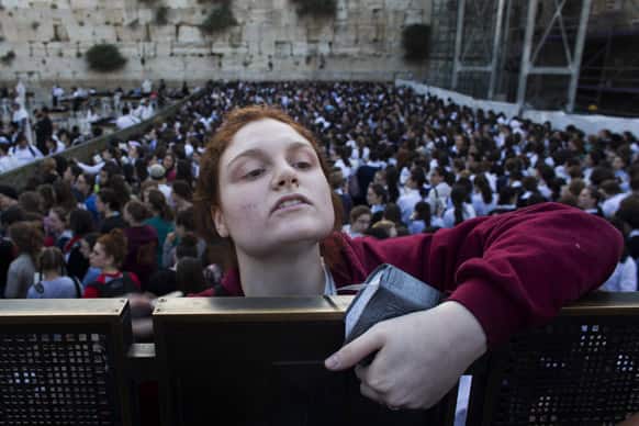 A Jewish orthodox women follows a prayer organized by the
