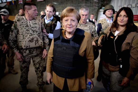 German Chancellor Angela Merkel is dressed in a bullet proofed vest as she arrives to Mazar-e-Sharif, Afghanistan. Angela Merkel made a surprise trip to northern Afghanistan to visit her troops less than two weeks after insurgents killed a German special forces soldier.
