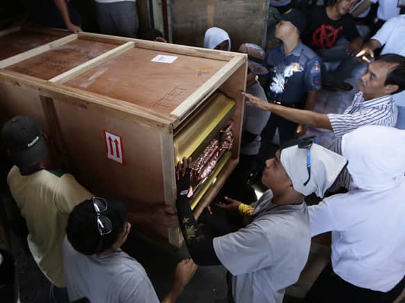 Airport workers load the casket of Vasco Jurian Stelter, 35, a German national and one of four foreigners killed in Tuesday`s eruption of Mayon volcano in Albay province in central Philippines, upon arrival in Manila.