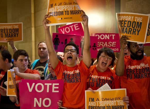 Advocates for both sides chant, sing and plead as they lined the entrance to the House floor as the House takes up the same-sex marriage bill in St. Paul, Minn.