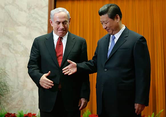 Israel`s Prime Minister Benjamin Netanyahu, left, prepares to shake hands with China`s President Xi Jinping at the Great Hall of the People in Beijing.
