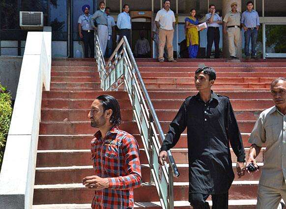 Family members, left and second from left, arrive to receive the body of Pakistani man Sanaullah Ranjay at a hospital in Chandigarh, India.