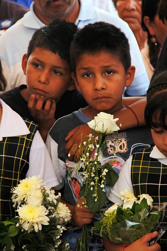 Young friends and relatives of people who died due to a gas tanker explosion attend wakes for the victims in Ecatepec, a Mexico City suburb.
