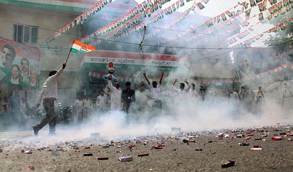 Congress party supporters celebrate after news of the party leading in the recently held state elections in Bangalore, India.