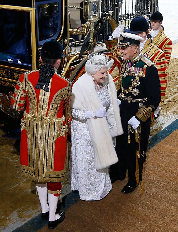 Britain`s Queen Elizabeth II and The Duke of Edinburgh laugh as they arrive for the State Opening of Parliament, at the Houses of Parliament in London.