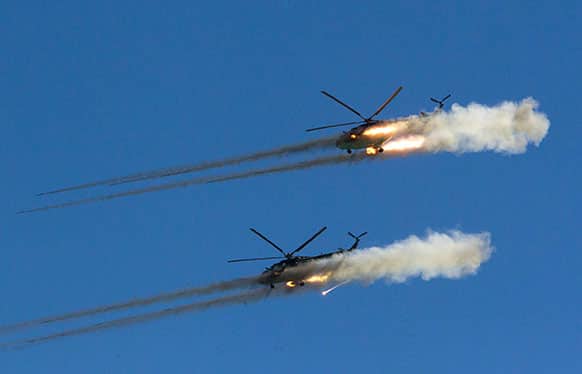 Kazakhstan`s military helicopters fire rockets during a celebration of Defender of the Fatherland Day to honor the achievement of military forces and veterans in the country at Otar military range in Kazakhstan.