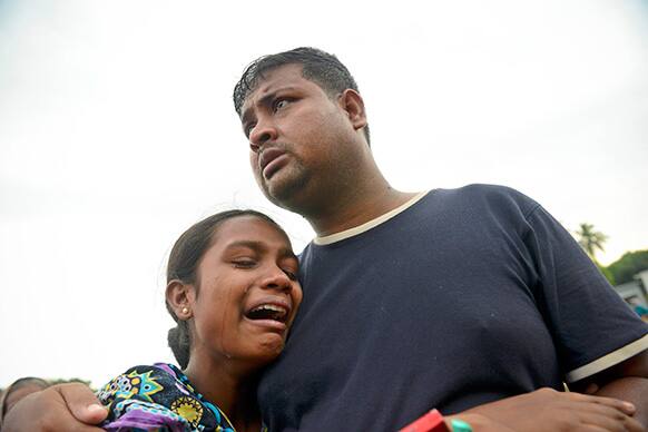A Bangladeshi woman cries after identifying the body of her father at a makeshift morgue near the site of a building collapse in Savar, near Dhaka, Bangladesh.