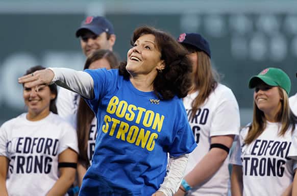 Patty Campbell, of Medford, Mass., mother of Krystle Campbell, who was killed in the Boston Marathon bombing, throws out a ceremonial first pitch prior to a baseball game between the Boston Red Sox and the Minnesota Twins at Fenway Park in Boston.