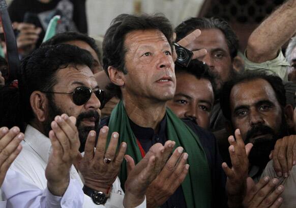 Imran Khan, Pakistan`s cricket star-turned-politician offers prayers at the mausoleum of Mohammad Ali Jinnah, founder of Pakistan during an election campaign in Karachi.