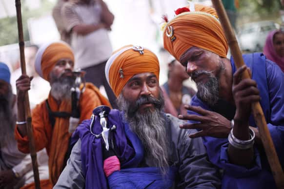 Sikhs talk while listening to a speaker as they protest the acquittal of ruling Congress party leader Sajjan Kumar in New Delhi.