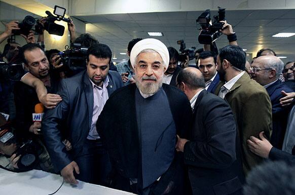 Former Iranian nuclear negotiator Hasan Rowhani, center, arrives at the interior ministry to register his candidacy for the upcoming presidential election, in Tehran, Iran.