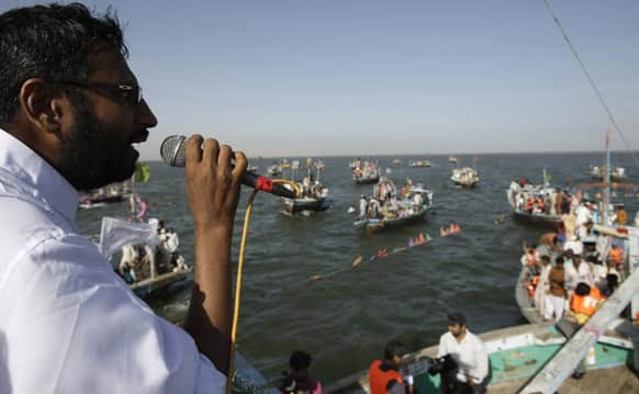 Pakistani election candidate Usman Ghani addresses fishermen living in his constituency during a campaign in the Arabian Sea near the coastal area of Karachi, Pakistan.
