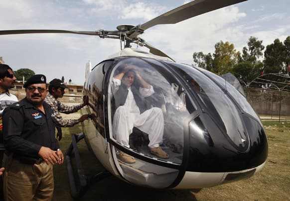 Pakistan`s former cricket star-turned-politician Imran Khan gestures from inside a helicopter as he prepares to leave after addressing an election campaign rally in Charsadda, Pakistan.