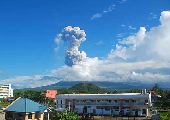 A mushroom of volcanic ash shoots up to the sky as Mayon volcano, one of the Philippines` most active volcanoes, spewed huge rocks and ash after daybreak Tuesday, May 7, 2013.