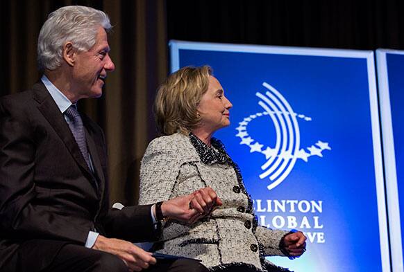 Former President Bill Clinton and former Secretary of State Hillary Clinton holds hands after she introduced Rio de Janiero Mayor Eduardo Paes at the Clinton Global Initiative (CGI) Mid-Year Meeting in New York.