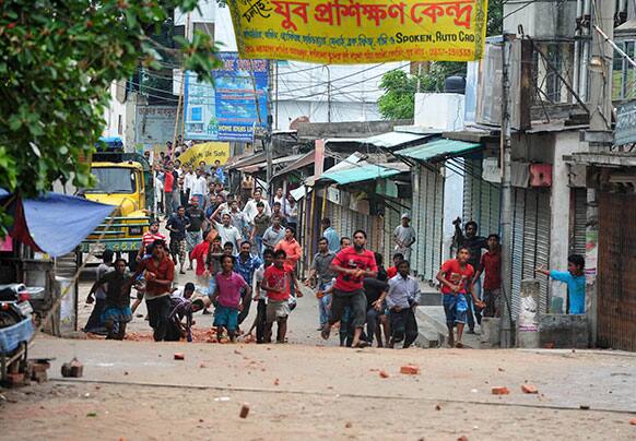 Protesters prepare to throw bricks during clashes between police and Islamic hardliners in Dhaka, Bangladesh.