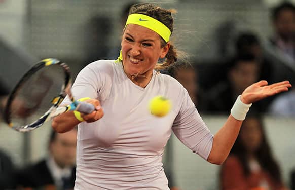 Victoria Azarenka from Belarus returns the ball to Anastasia Pavlyuchenkova from Russia during the Madrid Open tennis tournament.