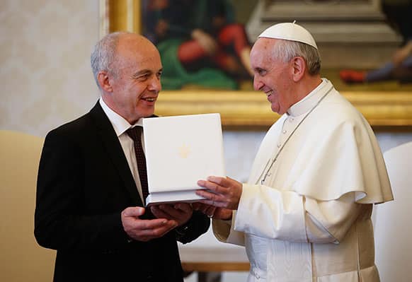 Pope Francis exchanges gifts with the President of the Swiss Confederation Ueli Maurer during a private audience at the Vatican.