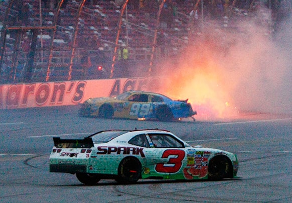 Austin Dillon (3) spins as Alex Bowman (99) catches fire in a last-lap wreck during the NASACR Nationwide Series auto race at Talladega Superspeedway in Talladega, Ala.