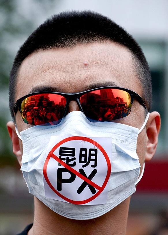 A Chinese man wears a face mask with the word