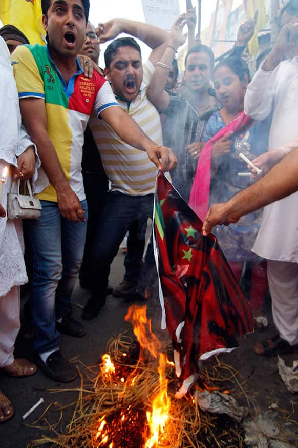 Activists of Jammu and Kashmir Democratic Front burn a flag of China during a protest against an alleged incursion by Chinese troops into Indian territory, in Jammu.