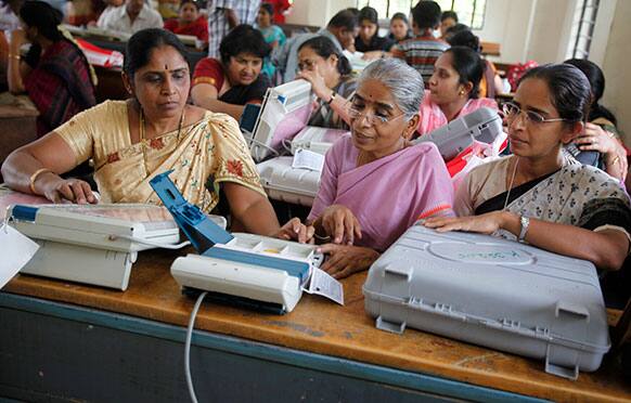 Indian polling officials inspect the performance of electronic voting machines before heading to their respective polling stations on the eve of state elections in Bangalore.