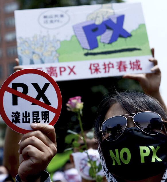 Chinese people wear face mask and hold papers with words that read: