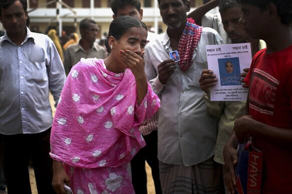 A young woman wails after identifying one of the many bodies at a morgue to be her relative, in Savar, near Dhaka, Bangladesh.