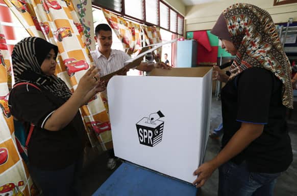 Election commission officials set up a ballot box at a voting center in downtown Kuala Lumpur. Malaysia will hold general elections on May 5 in what could be the toughest test of the ruling coalition`s 56-year grip on power.