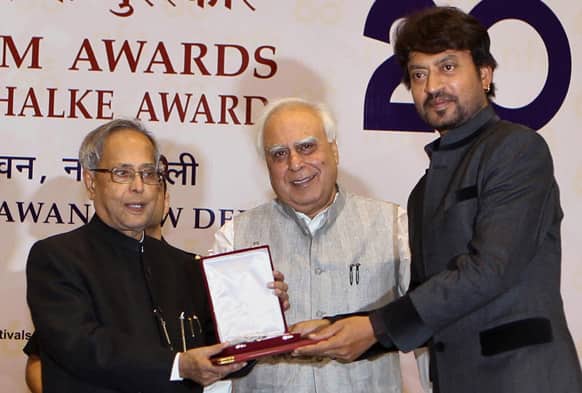 Bollywood actor Irfan Khan receives the Best Actor award from Indian President Pranab Mukherjee during the National Film Awards 2012, in New Delhi.